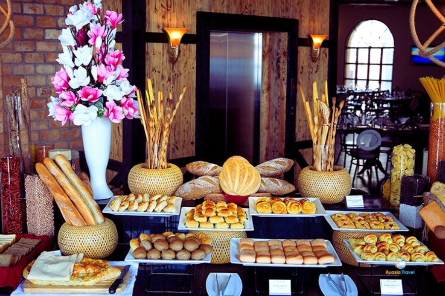 Breakfast buffet table with fresh breads and pastries at hotel in Vietnam – Auasia Travel